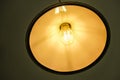 Interior design of lamp. A LED light bulb is illuminating and hanging under a house roof Royalty Free Stock Photo