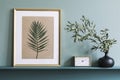 Stylish living room with mock up photo frame on the green shelf.