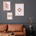 Interior design of living room interior with mock up poster frame, brown sofa, patterned rug, wooden coffee table, vase with dried Royalty Free Stock Photo