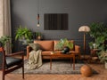 Interior design of living room interior with mock up poster frame, brown sofa, plants, wooden coffee table, lamp, ball, stylish Royalty Free Stock Photo