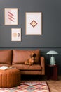 Interior design of living room interior with mock up poster frame, brown sofa, round pouf, patterned rug, wooden coffee table, Royalty Free Stock Photo