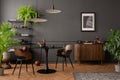 Interior design of living room interior with mock up poster frame, round black coffee table, wooden sideboard, stylish chair, Royalty Free Stock Photo