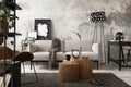 Interior design of loft apartment with mock up poster frame, gray sofa, modern lamp, wooden round coffee table, desk, gray rug, Royalty Free Stock Photo