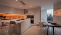Interior design of minimalist kitchen integrated with dining area with orange lights at night Royalty Free Stock Photo