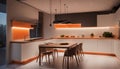 Interior design of minimalist kitchen integrated with dining area with orange lights at night Royalty Free Stock Photo