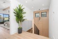 Interior design of a modern house corridor with white walls and wooden staircase Royalty Free Stock Photo