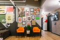 Interior design with orange chairs and lots of photos on the wall