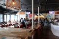 Interior design with people eating and shuffle boards set up for play, Flatbread Social, Saratoga Springs, New York, 2019