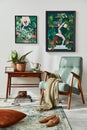 Interior design of retro living room with stylish vintage armchair, shelf, house plants, decoration and mock up poster frame. Royalty Free Stock Photo