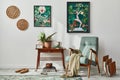 Interior design of retro living room with stylish vintage armchair, shelf, house plants, decoration and two mock up poster frames. Royalty Free Stock Photo