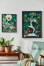 Interior design of retro living room with stylish vintage armchair, shelf, house plants, decoration and two mock up poster frames. Royalty Free Stock Photo