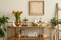 Interior design of spring living room interior with mock up poster frame, glass vase with tulips, wooden sideboard, hare sculpture Royalty Free Stock Photo