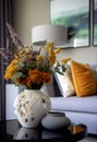 Interior design with a vase and a bouquet of summer wildflowers on the table. Elements of home decor. AI Generated