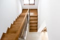 Interior design. Wooden minimalist staircase in luxury home. Modern Architectural loft with wooden steps