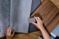 An interior designer's hand selects a palette of sample materials that includes different types Royalty Free Stock Photo