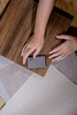 An interior designer's hand selects a palette of sample materials that includes different types Royalty Free Stock Photo