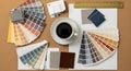 Interior designer\'s workspace with coffee and material samples Royalty Free Stock Photo