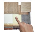 interior designer selects material samples contains oak wooden ceramic flooring tiles and drapery fabric catalog palette. Royalty Free Stock Photo