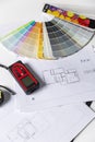 Interior designer tools. Laser meter, blueprints and color palette on the table. Vertical Royalty Free Stock Photo