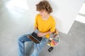 Interior designer works on project on laptop sitting on the floor. Royalty Free Stock Photo