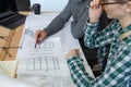 Interior designers team working in office with blueprints and architect equipment, sketching, negotiating and planning Royalty Free Stock Photo
