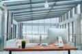 An interior of a desk with computer in modern spacious office.