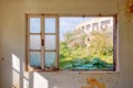 Interior of a desolated house and a window frame with broken glass