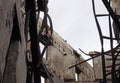 Interior of a destroyed industrial building with collapsing walls and twisted girders and fallen roof open to the sky