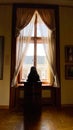 Interior detail with beautiful delicate curtains. Light breaks through the window.