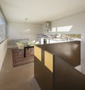 Interior detail of nmodern house in Switzerland, showing the kitchen and dining room with table and chairs