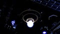 Interior details of an alien space ship with a glowing light bulb. Motion. Space aircraft dashboard with colorful