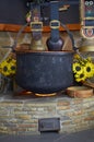 Interior details. Decorative fireplace with a pot, wide straps and sunflowers.