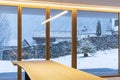 Interior of a dining room, with a large bay window, no one inside and outside there is snow Royalty Free Stock Photo