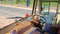 Interior of driver space in indian local bus showing steering and speedometers