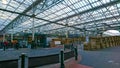 Interior of Edinburgh Waverley Station with glass ceiling and a road exit