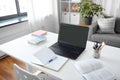 laptop, notebook and book on table at home office Royalty Free Stock Photo