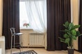 Interior element, bar stool, curtain windows, vase with flowers on the window Royalty Free Stock Photo