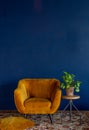 Interior element, yellow empty armchair against blue wall background, copy space