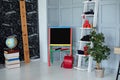 Interior of elementary school. Chalkboard, books, globe, red backpack, pencils and stationery in classroom. Back to school. Classr