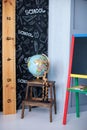 Interior of elementary school. Chalkboard, Books, globe and stationery on classroom. Teachers Day concept. Back to school. Empty c