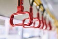 Interior elements of public transport - city bus grab handles - on a blurred background Royalty Free Stock Photo