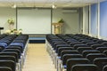 Interior of Empty Conference Hall With Lines of Blue Chairs in F Royalty Free Stock Photo