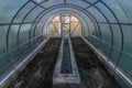 Interior of empty greenhouse before spring with concrete walls Royalty Free Stock Photo