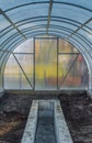 Interior of empty greenhouse before spring with concrete walls