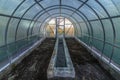 Interior of empty greenhouse before spring with concrete walls