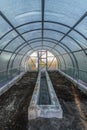 Interior of empty greenhouse before spring with concrete walls