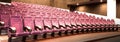 Interior of empty hall with red armchairs