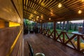 Interior of empty hall veranda in wooden village vacation home with vintage lamps and chairs