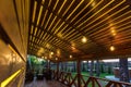 Interior of empty hall veranda in wooden village vacation home with vintage lamps and chairs