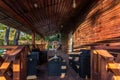 Interior of empty hall veranda in wooden village vacation home with vintage lamps and chairs